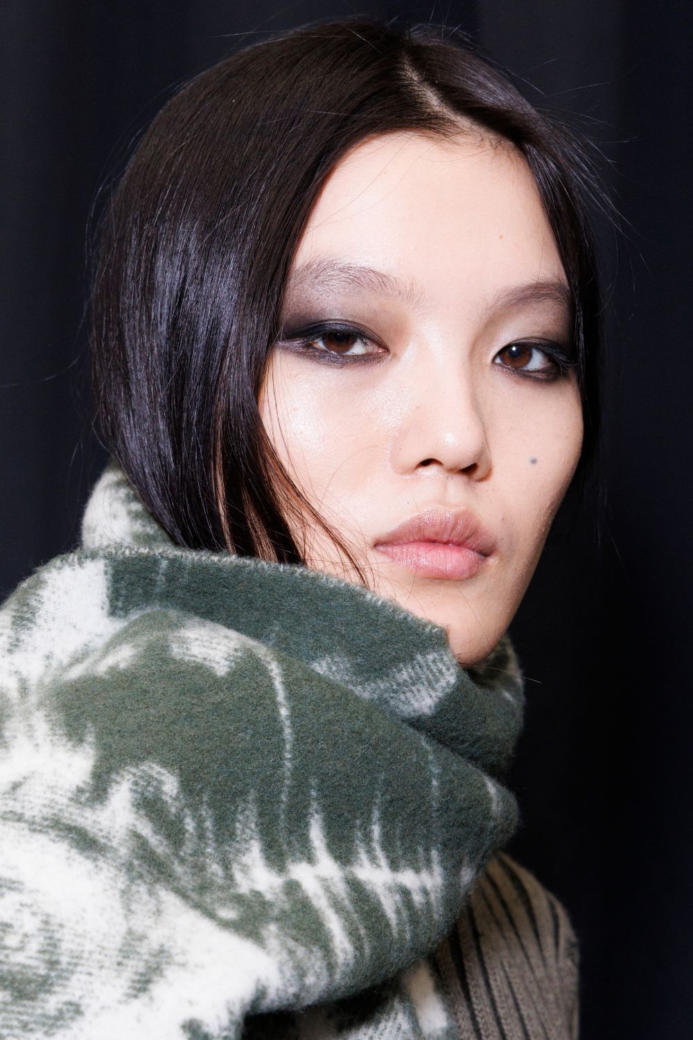 model backstage at milan fashion week with smokey eye makeup