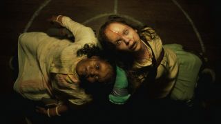 A possessed Lidya Jewett and Olivia Marcum staring straight up in The Exorcist: Believer.