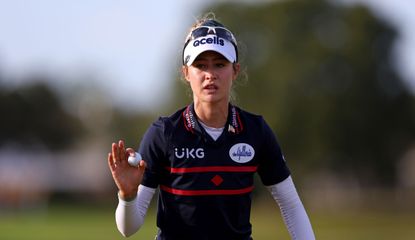 Nelly Korda waves to the crowd after holing a putt