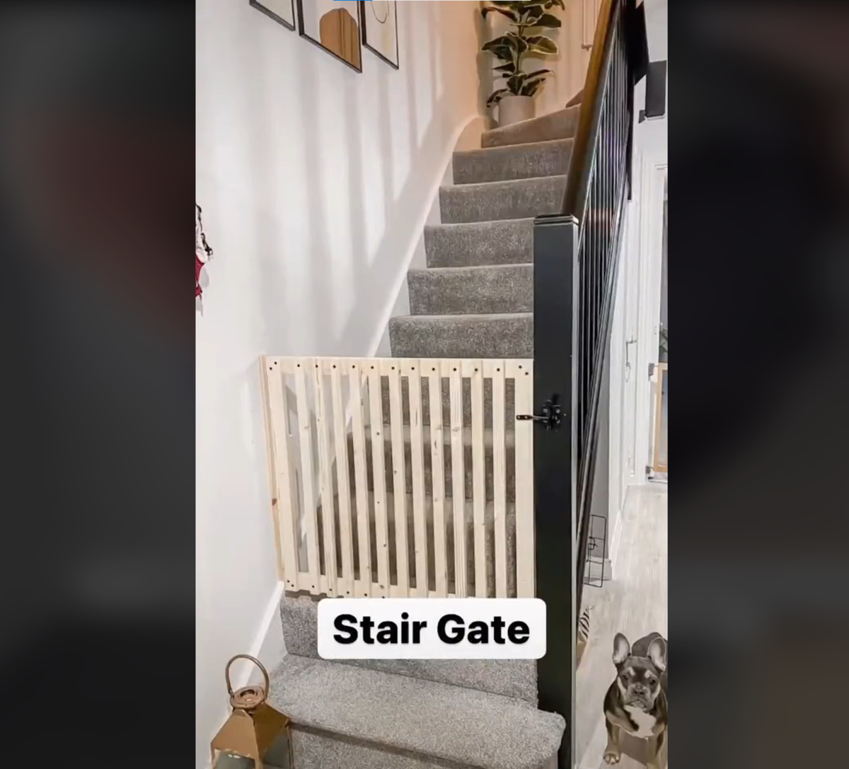 DIY stair gate made from wood stands at the bottom of the stands