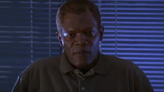 Samuel L Jackson stands in front of darkened blinds during an interrogation in The Negotiator.