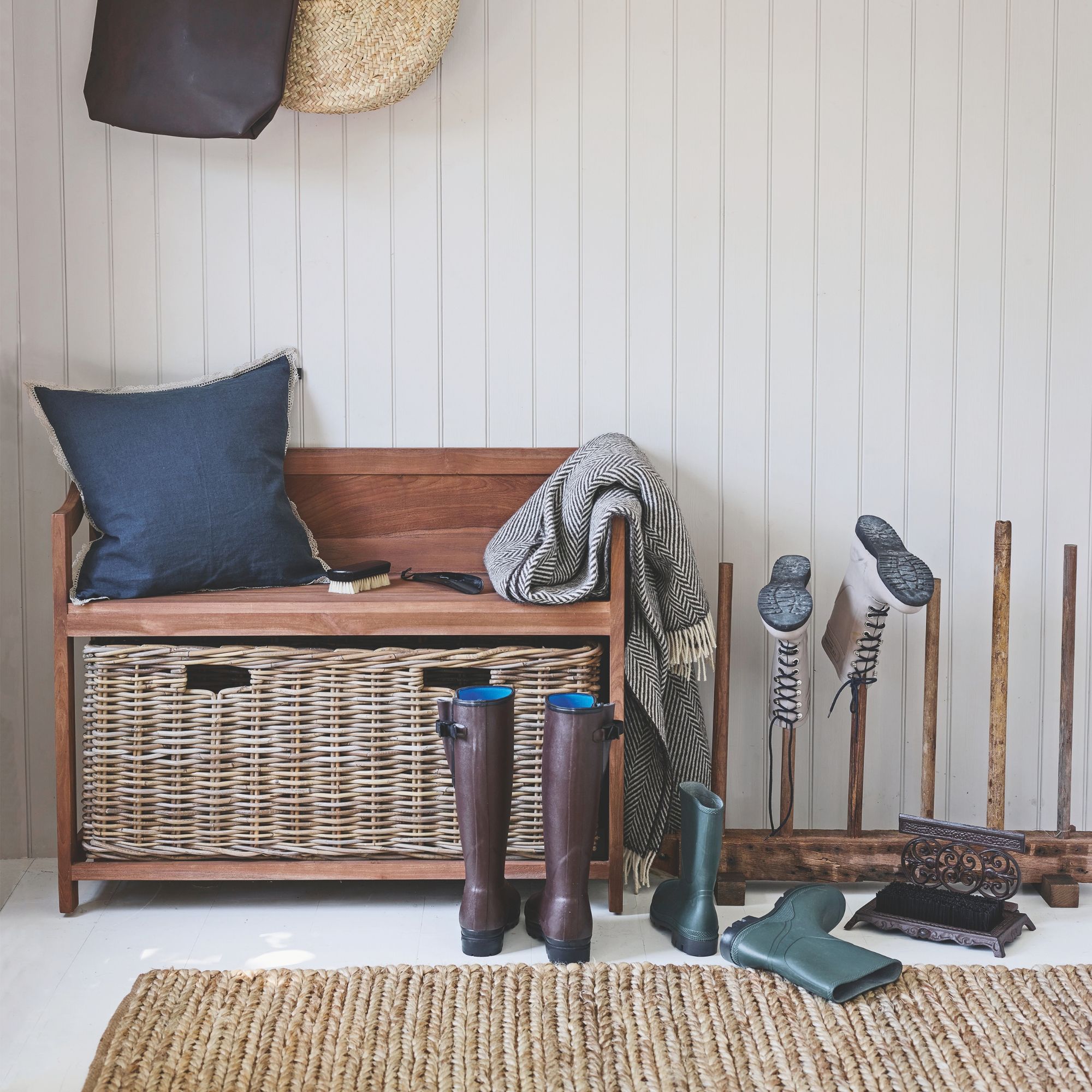 hallway with a storage bench and wellington boot storage next to it
