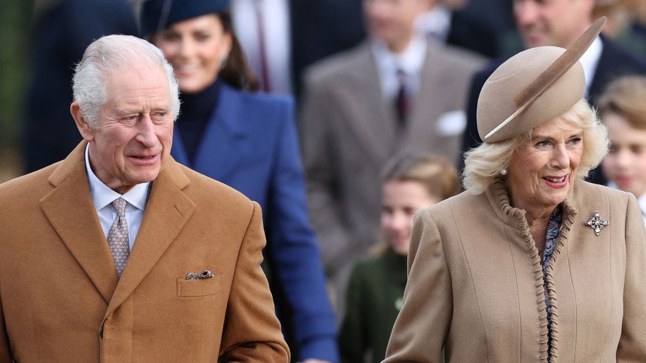 King Charles wears a camel coat as he attends church on Christmas Day with wife Queen Camilla, wearing a tan coat and matching hat