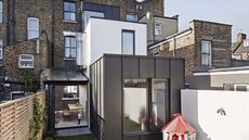 Double storey extension designed in layers, with white and black exteriors leading onto the garden, by Mulroy Architects