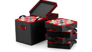 A black and red Christmas ornament storage box with three removable trays on the right of it, for the best ornament storage containers.