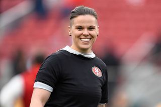 San Francisco 49ers offensive assistant Katie Sowers stands on the field before their NFC Championship game