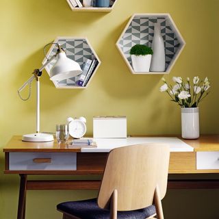 home office with yellow wall and desk and chair