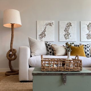 white room with wall art and green trunk