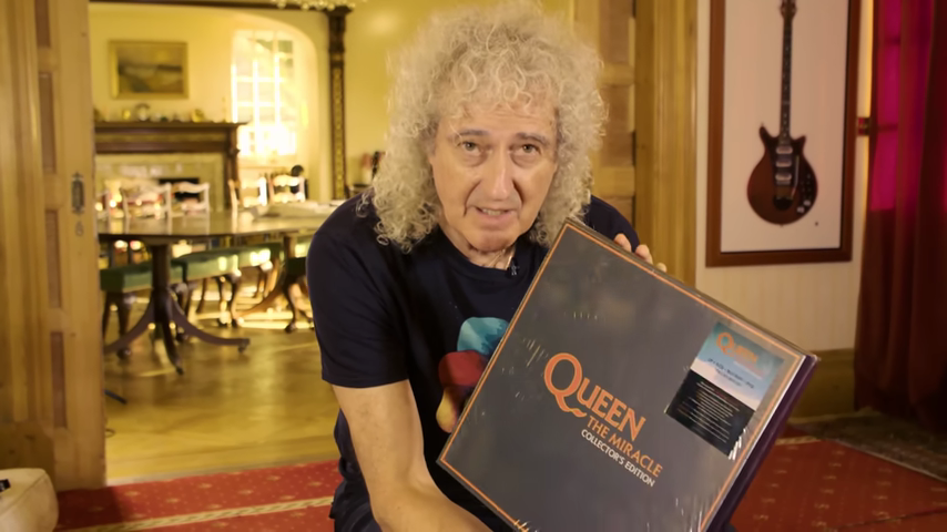 A picture of Brian May holding a box set