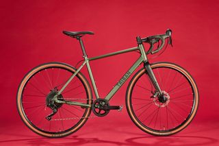 Triban 120 gravel bike on a red background