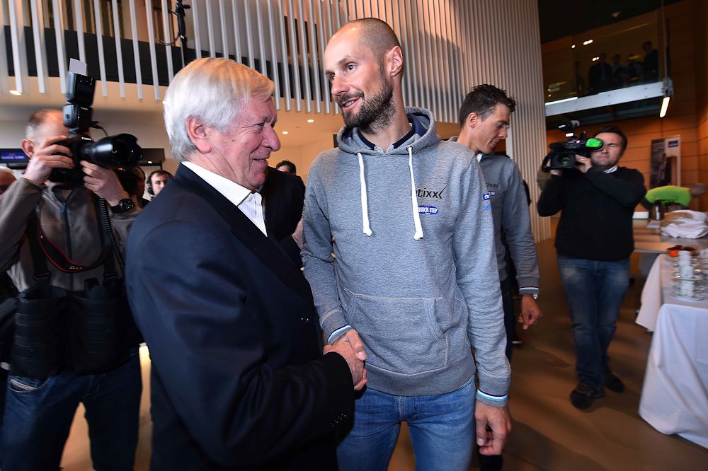 Tom Boonen shakes hands with Paul de Cock of Unilin Quick-Step Flooring.