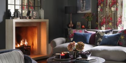 Cosy autumnal living room with open fire and coffee table