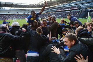 MILTON KEYNES, ENGLAND - DECEMBER 02: Players and fans celebrate as Jack Midson of AFC Wimbledon scores their first goal during the FA Cup with Budweiser Second Round match between MK Dons and AFC Wimbledon at StadiumMK on December 2, 2012 in Milton Keynes, England. This match is the first meeting between the two teams following the formation of AFC Wimbledon (the football club formed in 2002 by supporters unhappy with their club's relocation to Milton Keynes) and the MK Dons (which Wimbledon F.C. controversially became). (Photo by Michael Regan/Getty Images)