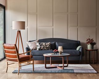 Sustainably made sofa from heals in front of panelled wall with leather armchair