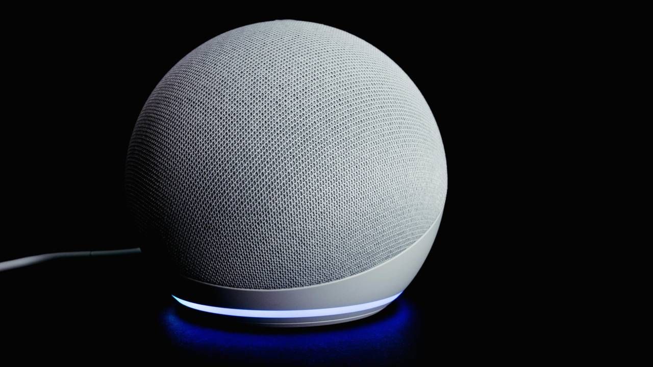 An Echo Dot sitting on a table with a black background