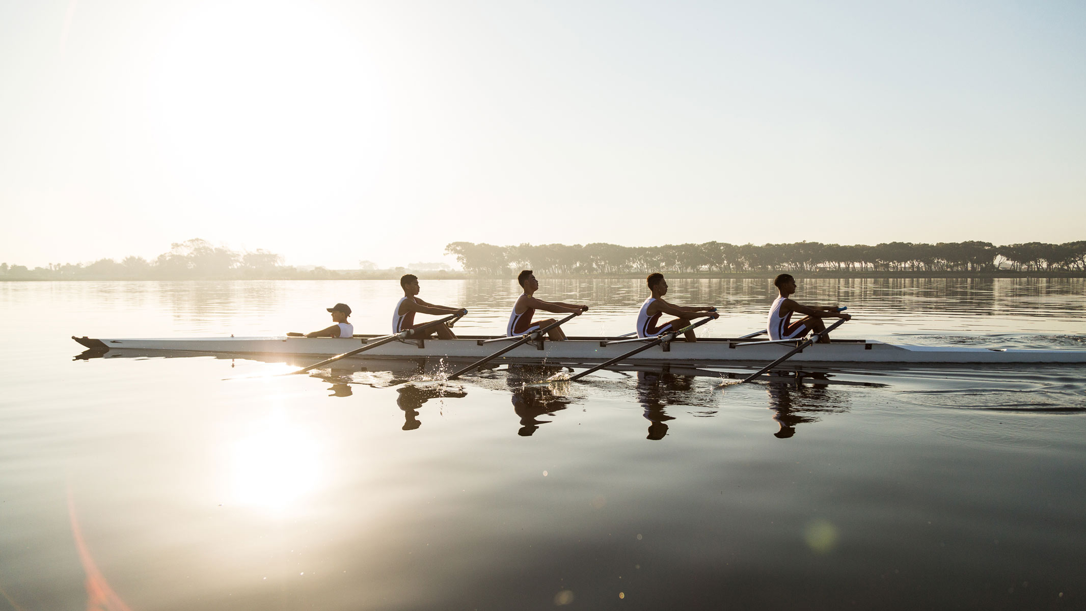 A group of elite rowers exercising in the morning