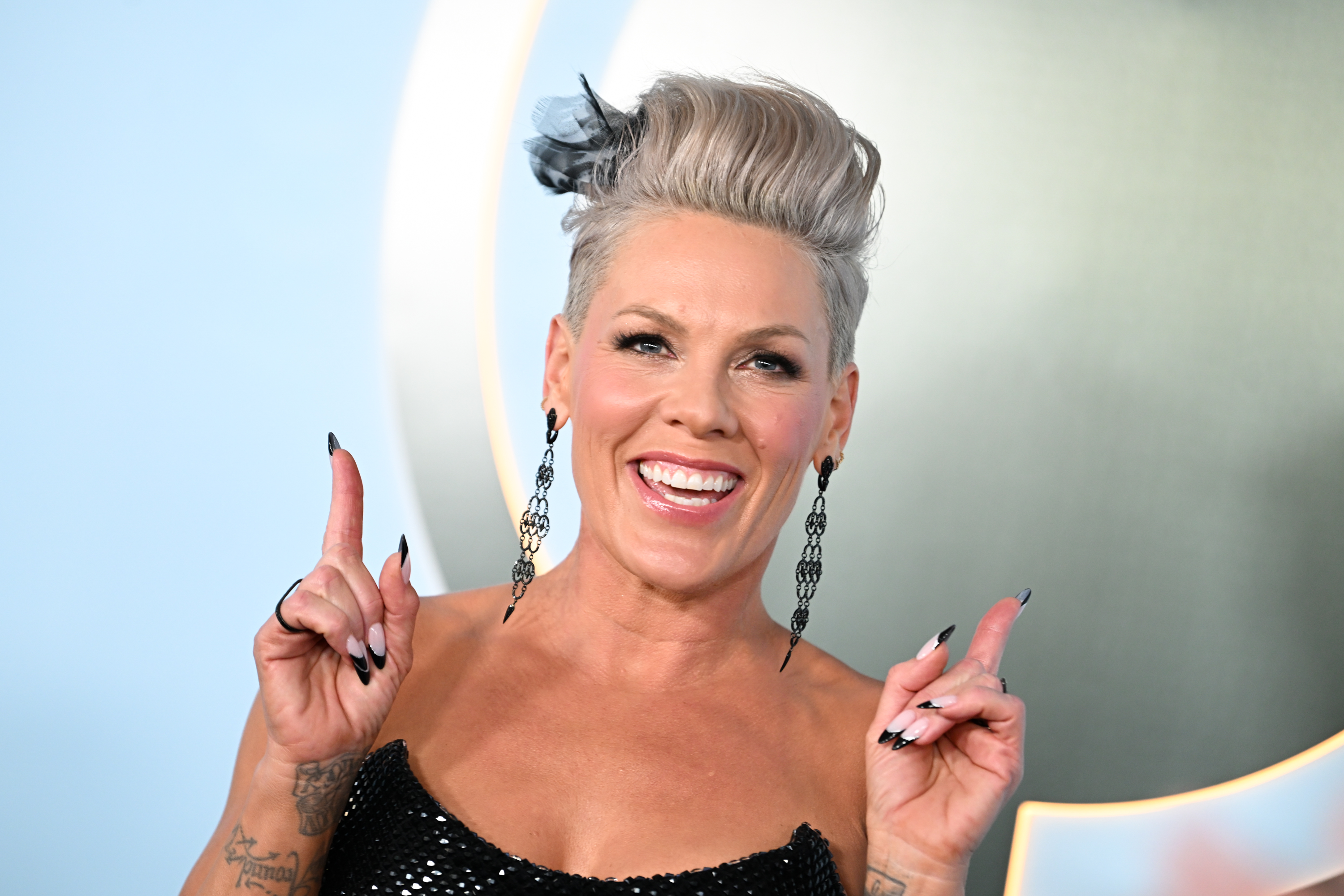 a white woman with short, blonde hair smiles during a red carpet event