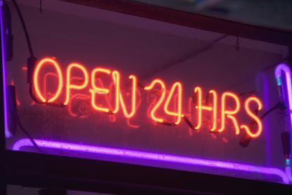 neon sign with red letters spelling out "open 24 hours"