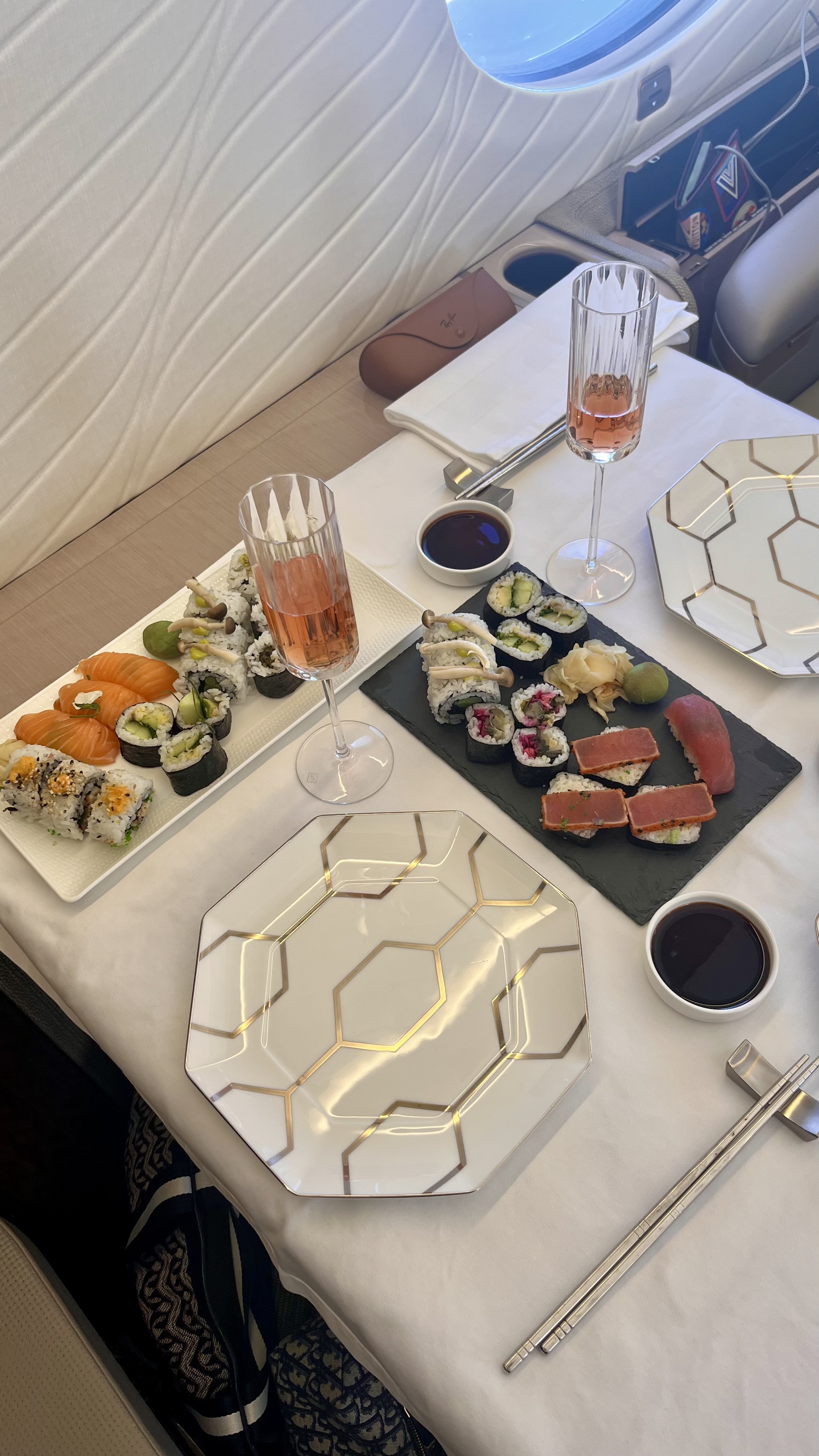 Platters of sushi, Champagne and hexagonal plates, decorated with a gold pattern