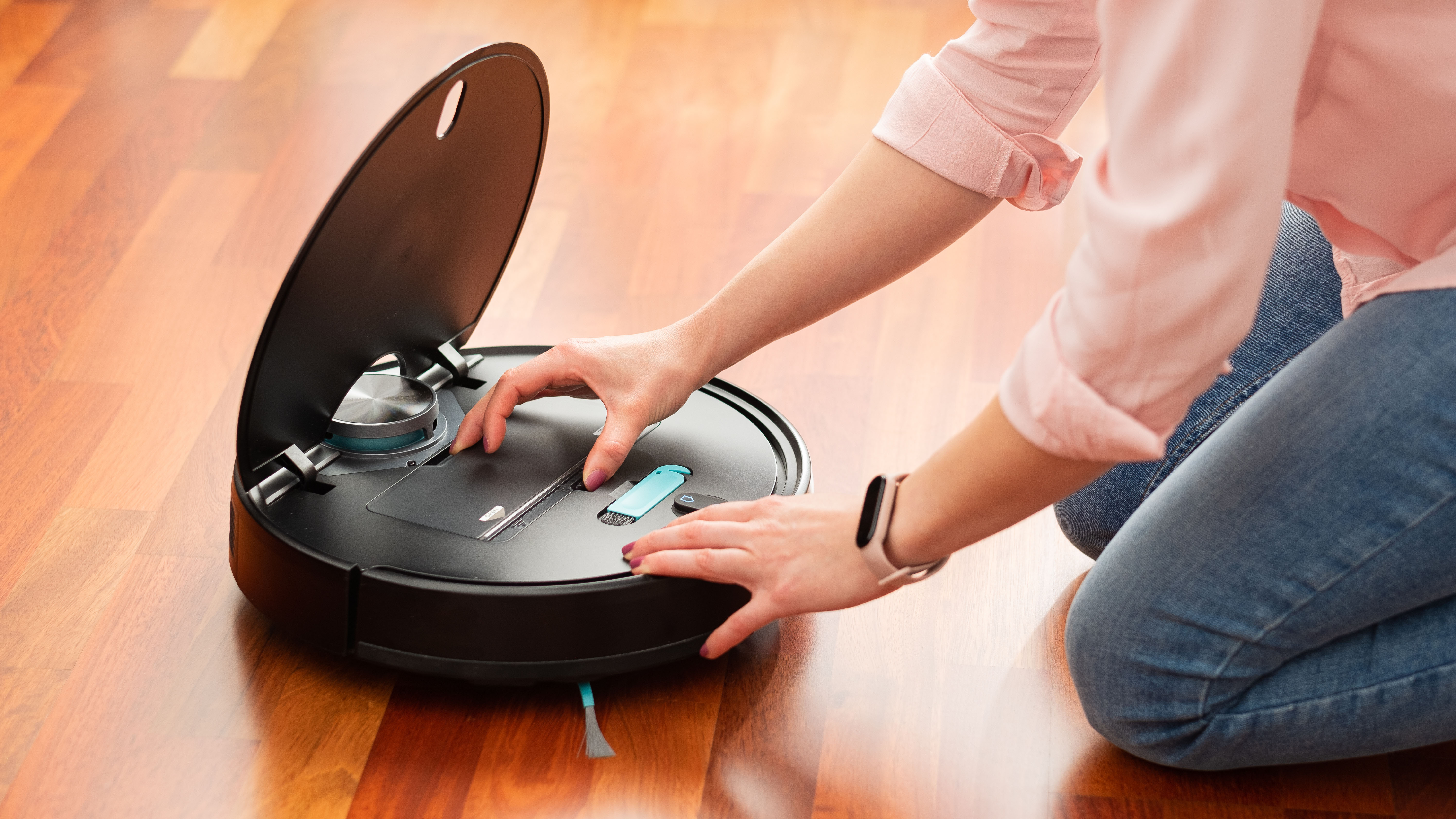 A robot vacuum's dustbin being emptied