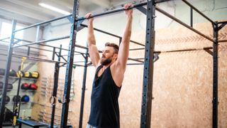 Tricep and chest workout: Active hang move at gym