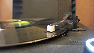 a closeup of the tone arm on the victrola revolution go record player