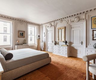 bedroom with beige paint and ornate molding