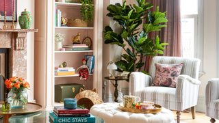 reading nook with stripey chair. bookcase and plant to the left hand side.