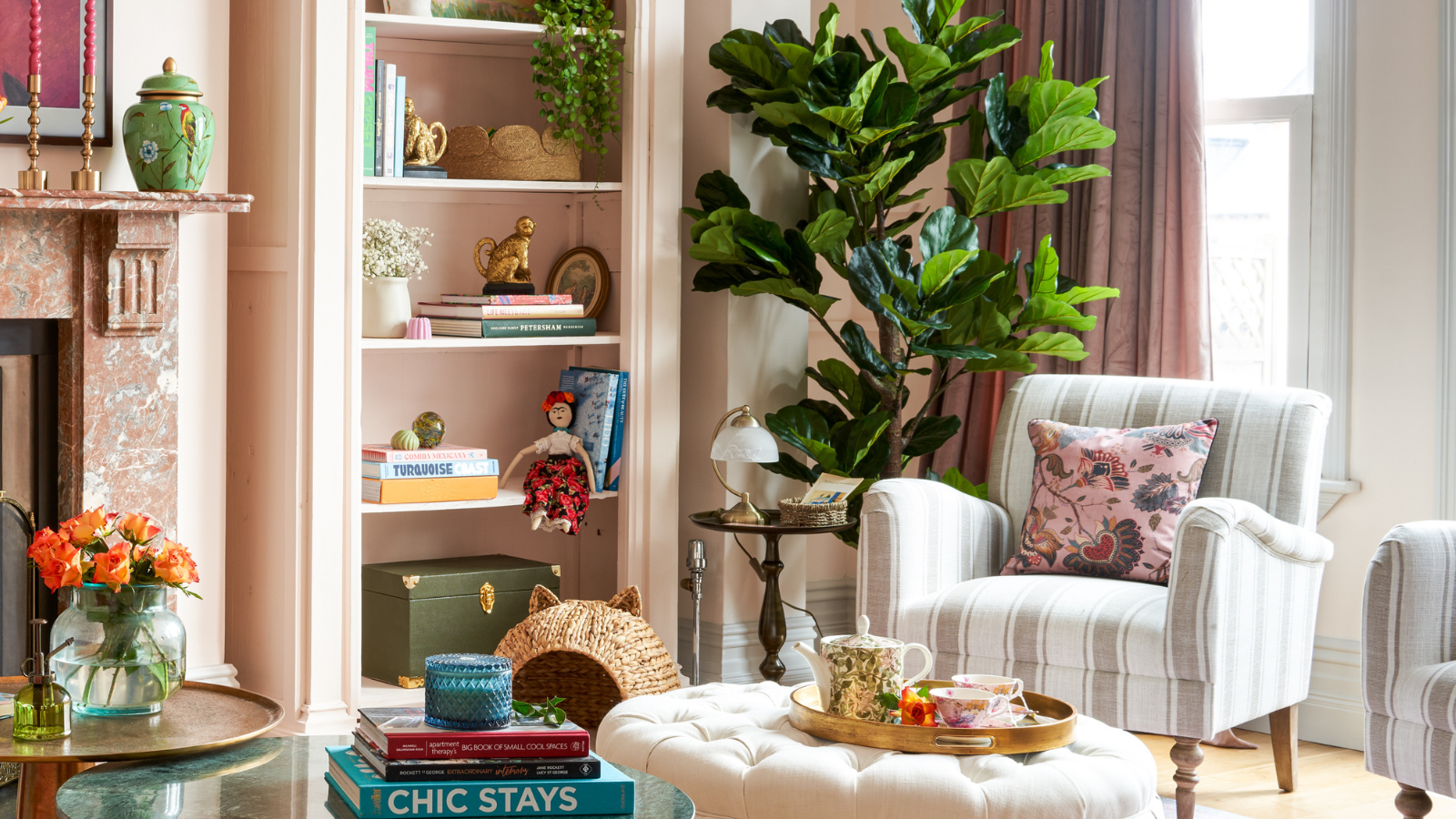 reading nook with stripey chair. bookcase and plant to the left hand side.