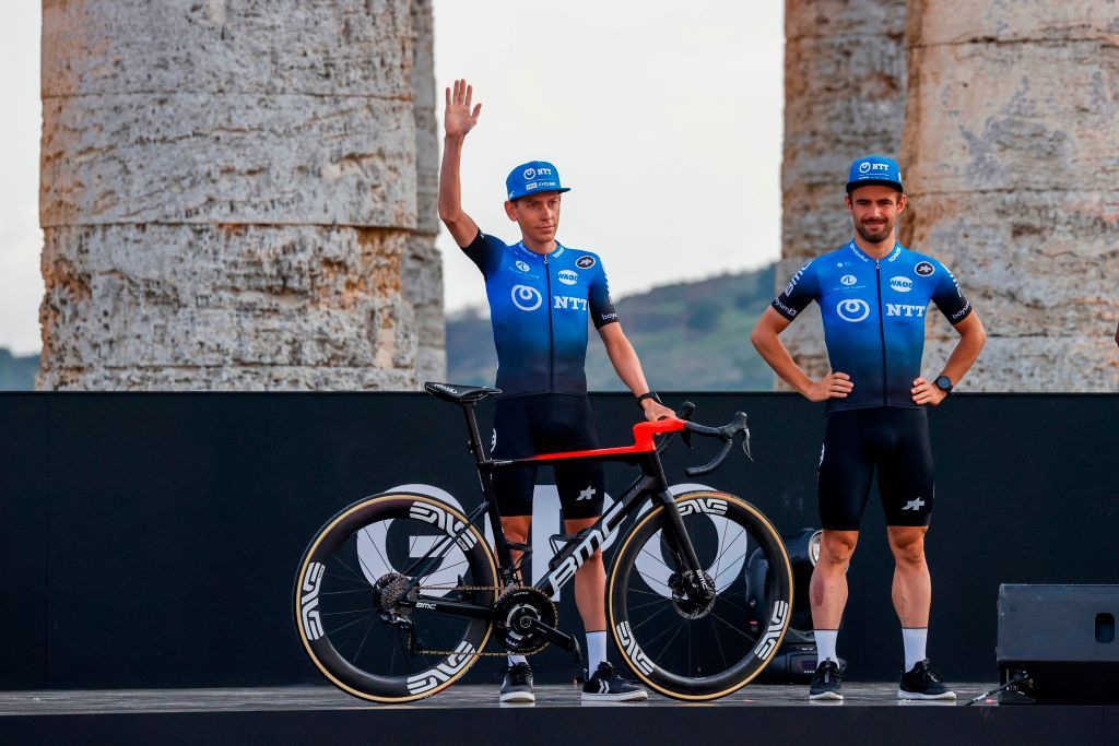 South Africas Louis Meintjies L of NTT Pro Cycling Team waves on stage at the Doric Temple of Segesta near Palermo Sicily on October 1 2020 during an opening ceremony of presentation of participating teams and riders two days ahead of the departure of the Giro dItalia 2020 cycling race Photo by Luca Bettini AFP Photo by LUCA BETTINIAFP via Getty Images