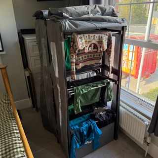 drysoon trimode heated hub with clothes in bedroom