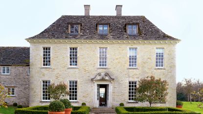 exterior of classic Cotswold stone Georgian style newbuild country house