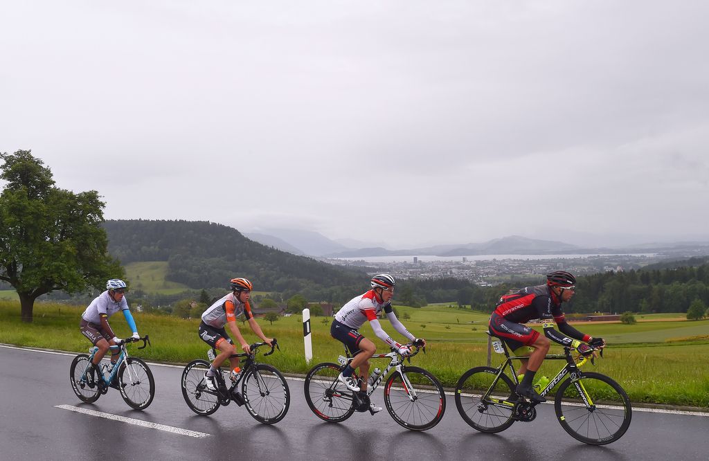 The four-man breakaway riding through the rain