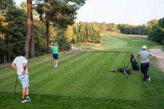 A golfer teeing off