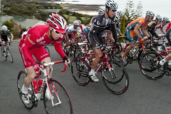 Peter McDonald (left) of Drapac Porsche wrestles with his bike on the climb in Devonport.