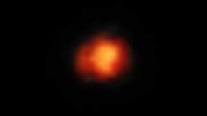 A fiery orange smudge representing Maisie's galaxy, one of the earliesrt galaxies in the known universe