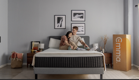 Couple lying down on mattress with emma sleep box