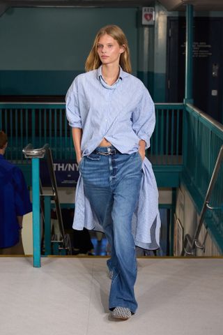 woman wearing button-down shirt and jeans on the Tommy Hilfiger runway