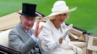 King Charles III and Queen Camilla salute the crowds on day one during Royal Ascot
