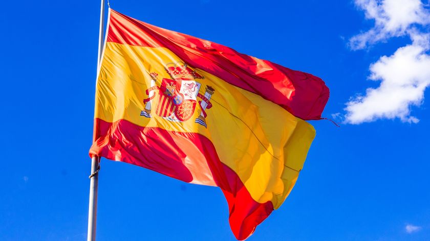 Big Spanish flag hanging from a mast - stock photo