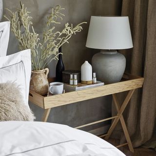 Southwold Table Lamp on bedside table next to electric diffuser, essential oils, and vase