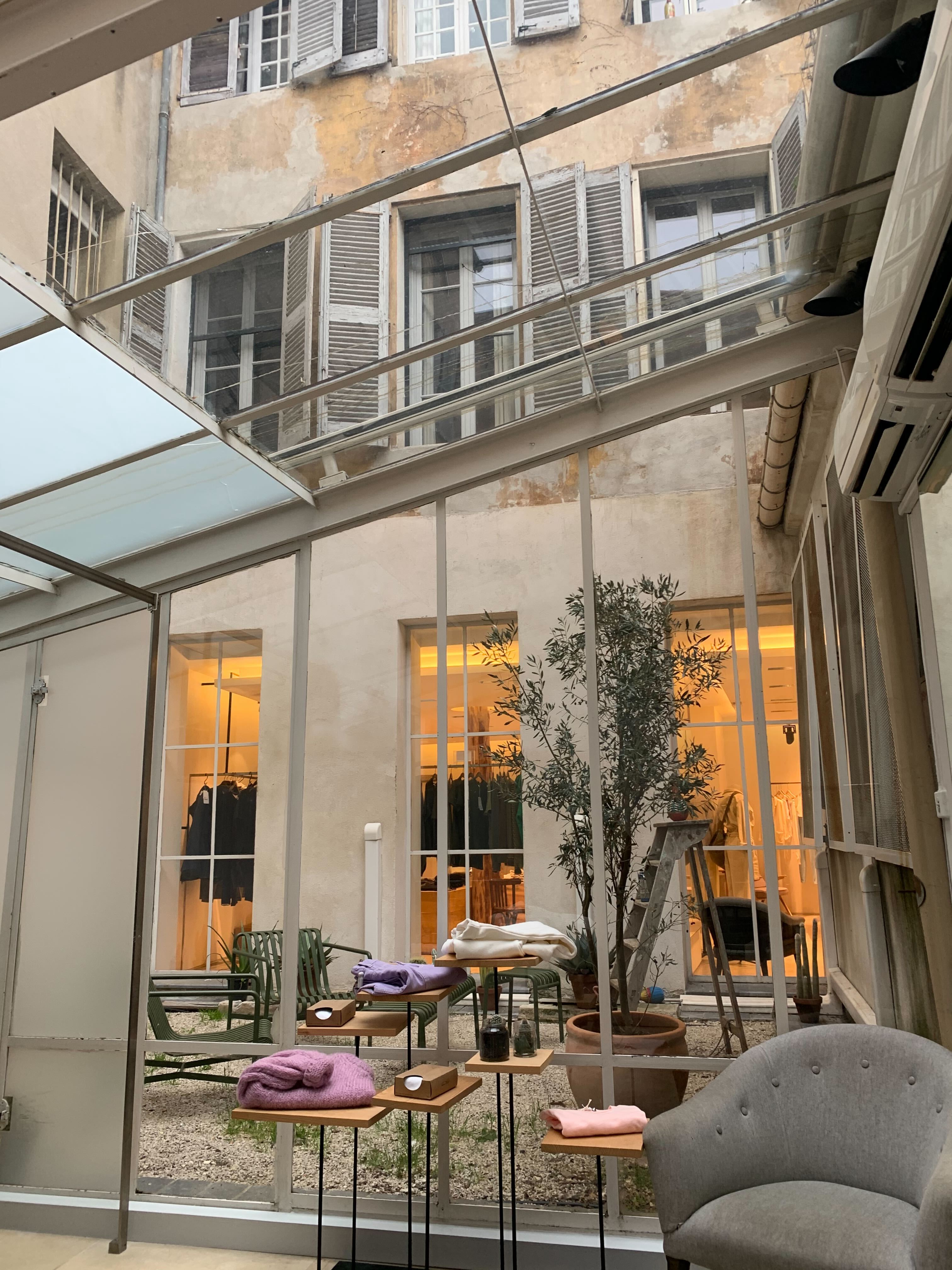A series of images depicting the architectural, design, and nature standouts of Aix-en-Provence features picturesque alleys wrapped in vegetation, modernist interiors, and snapshots of food.