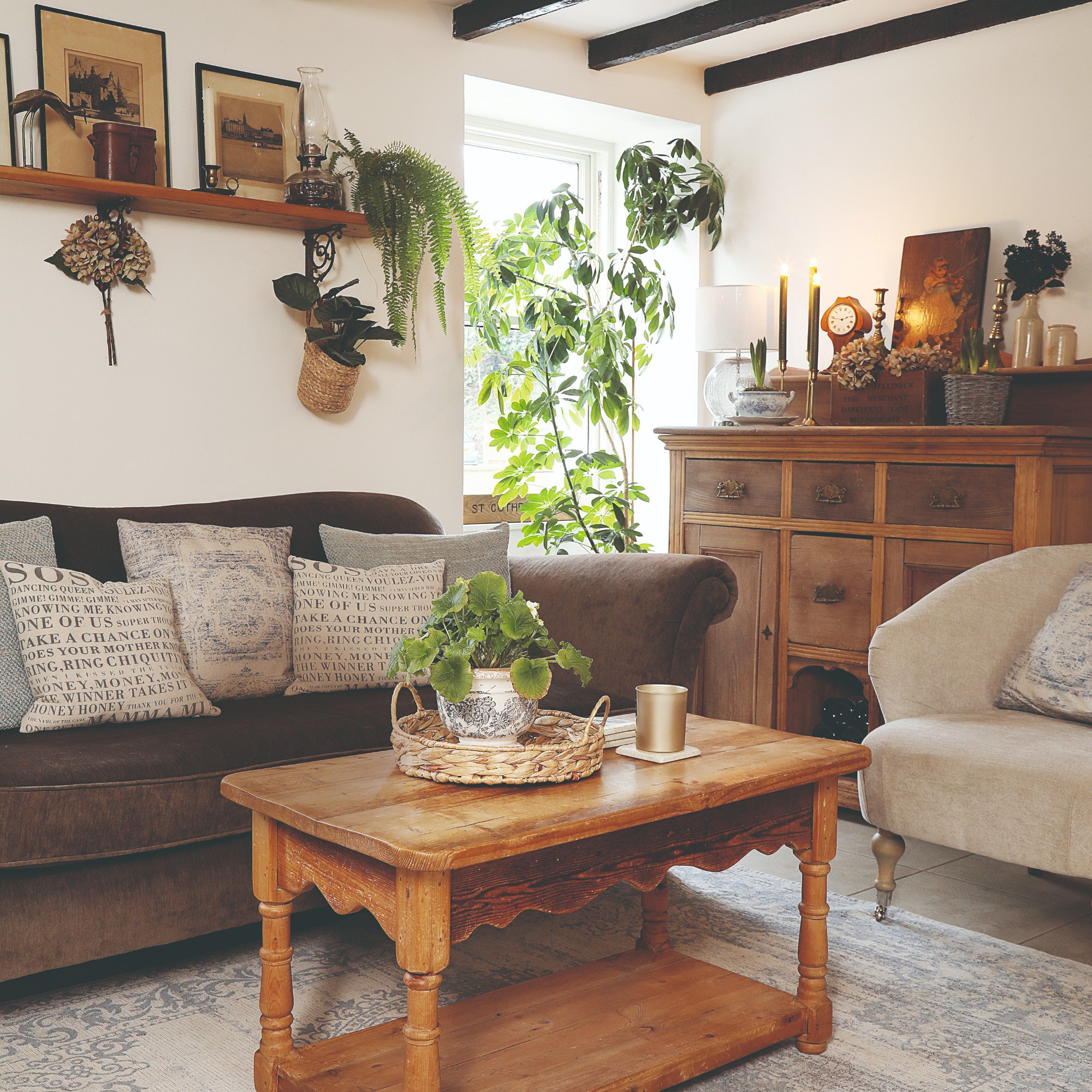 A small living room withba brown sofa with a shelf above it and a storage coffee table