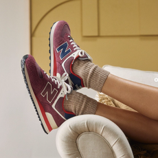 New Balance trainers on the edge of a sofa