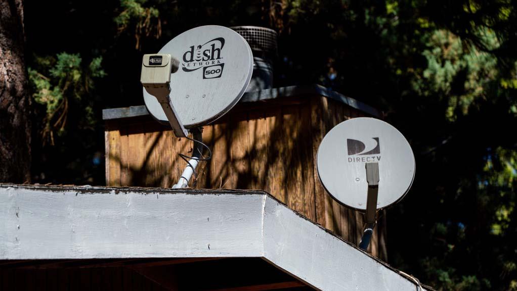 Dish TV and DirecTV recievers on the roof of a home in Wrightwood, Calif. 