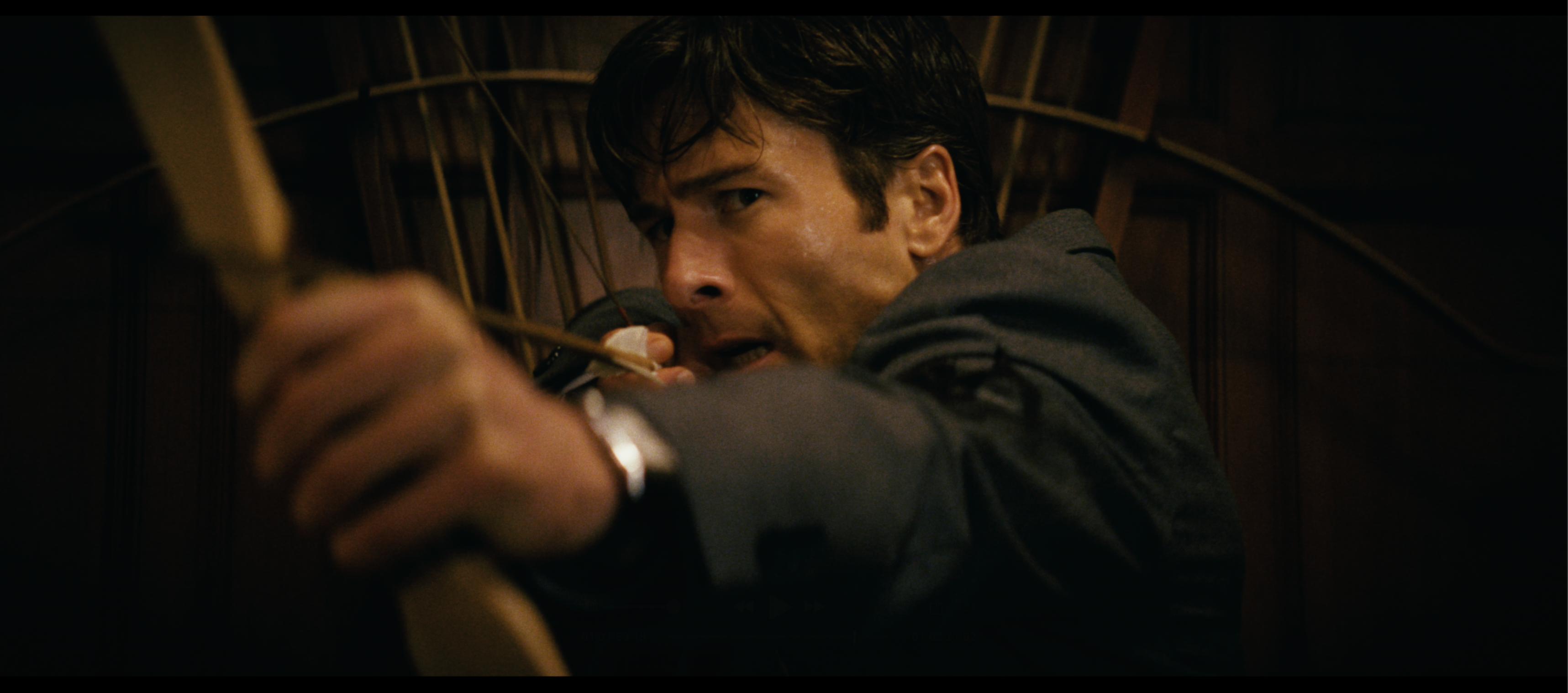 glen powell as becket aiming and shooting a bow and arrow in a still from the 2026 thriller how to make a killing