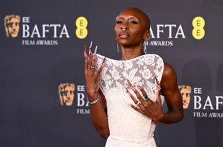 Cynthia Erivo wears a structural white lace gown on the red carpet of the BAFTAs 2025