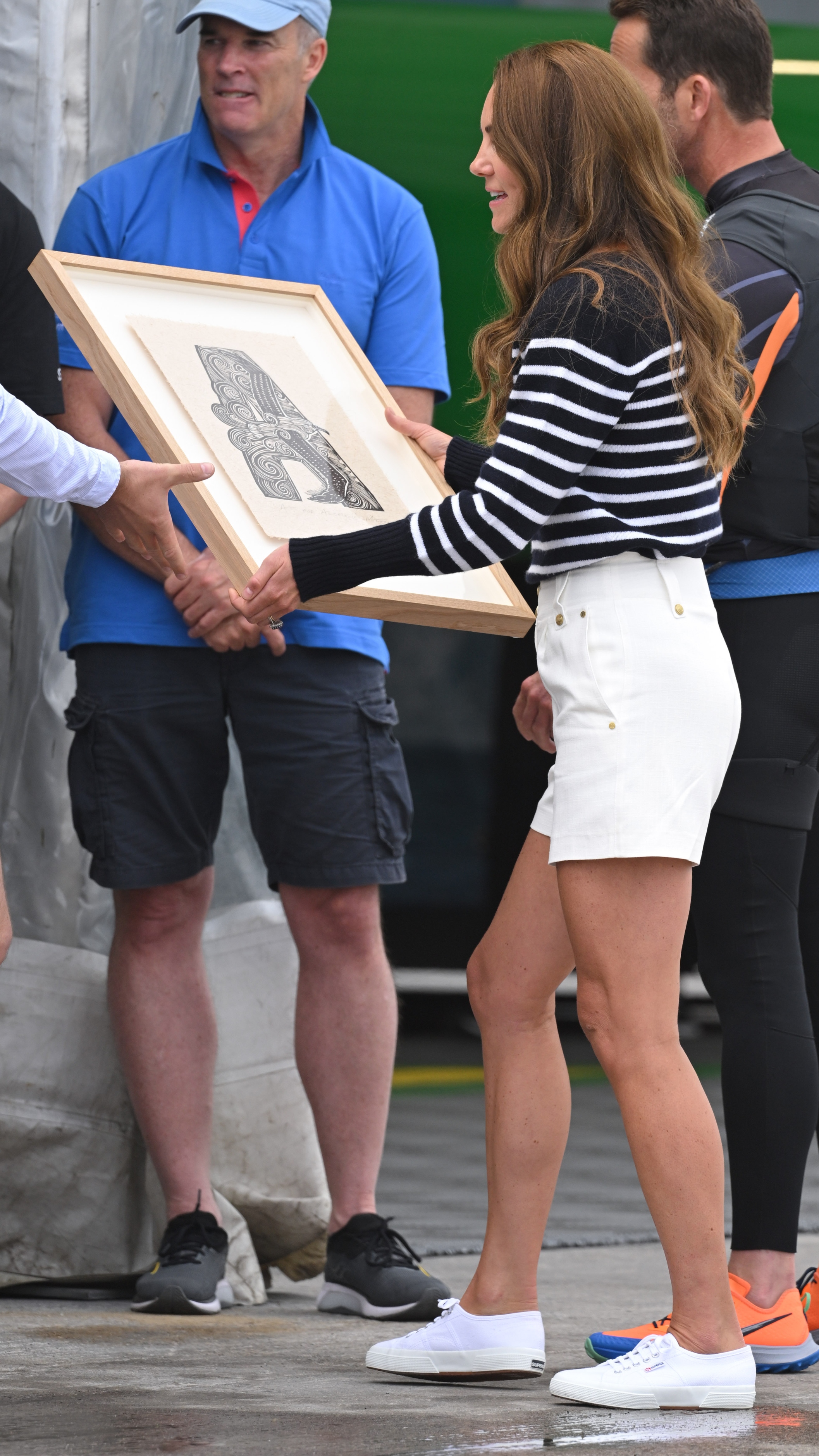 Catherine, Princess of Wales holds a picture during her visit to the 1851 Trust and the Great Britain SailGP Team on July 31, 2022