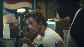 Liza Colón-Zayas, Jeremy Allen White, and Lionel Boyce talking around the counter in The Bear.
