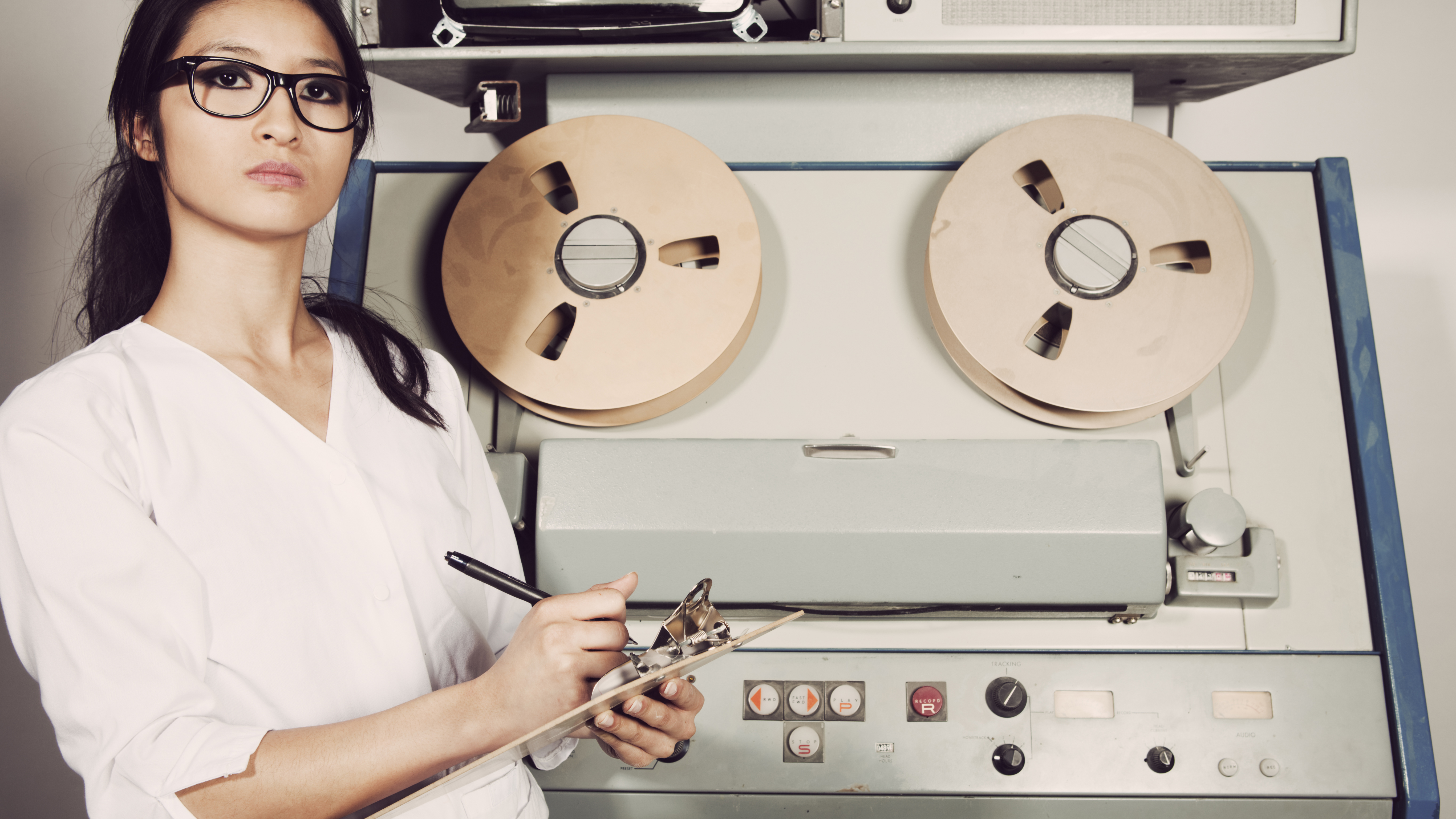 Young female scientist checking computer, 60s/70s vintage style.